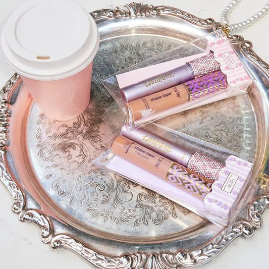 tarte cosmetics SPOTTED the icons best sellers set on a platter with a coffe