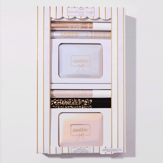 Cosmetic set features mascaras, palettes, and lip products arranged neatly in a striped box. The top reads: tarte kindness café. Context suggests a curated collection for beauty enthusiasts.