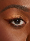 Close-up of a person's eye with brown makeup