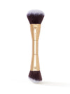 Makeup brush with gold handle and black bristles on a white background
