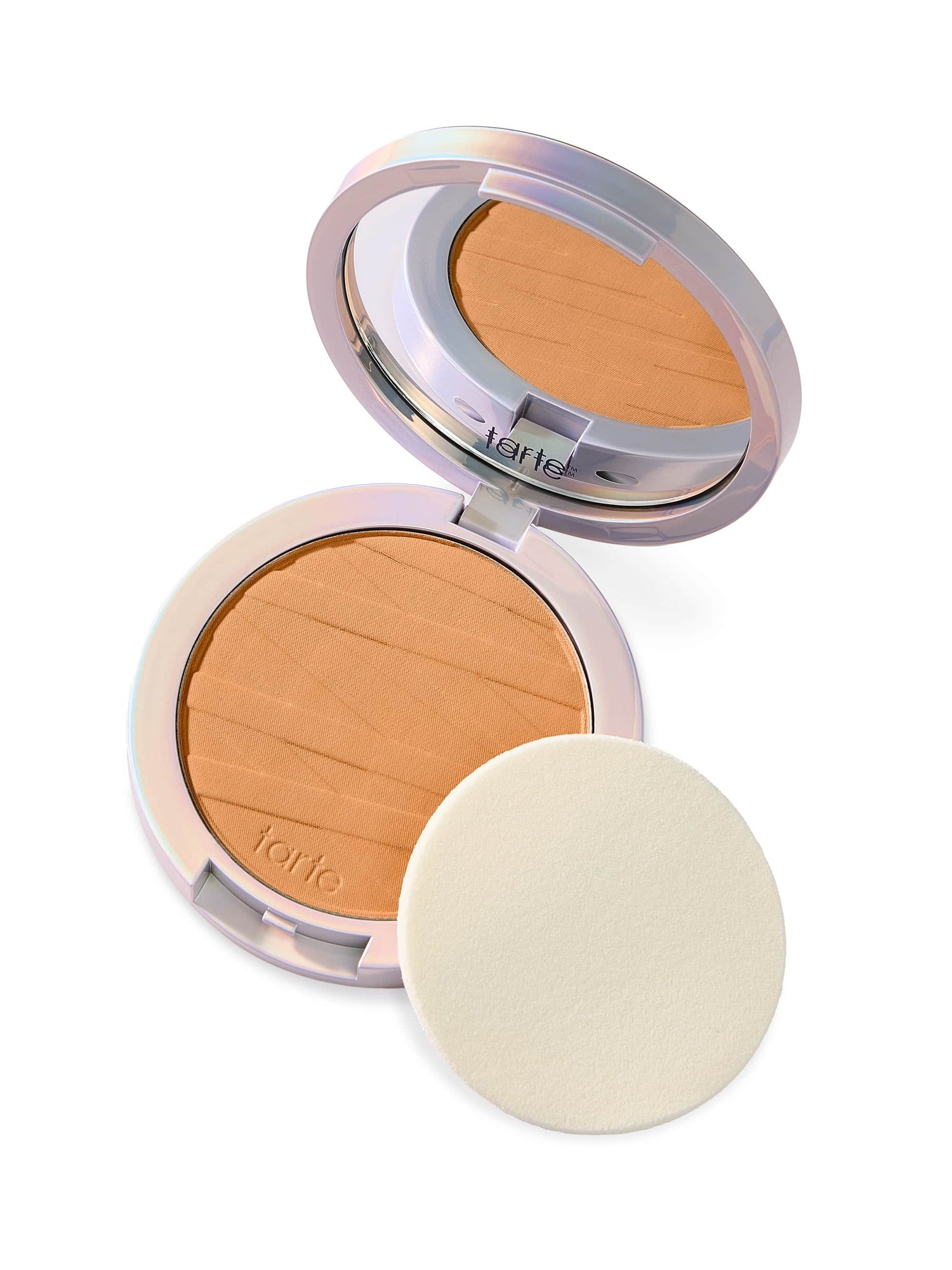 A compact with two open halves: one contains pressed powder, the other a mirror. A round sponge sits next to it on a white background.