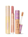 Collection of Tarte lip products including a tartelette tubing XL mascara, maracuja juicy lip plump, and tarte shape tape concealer. 