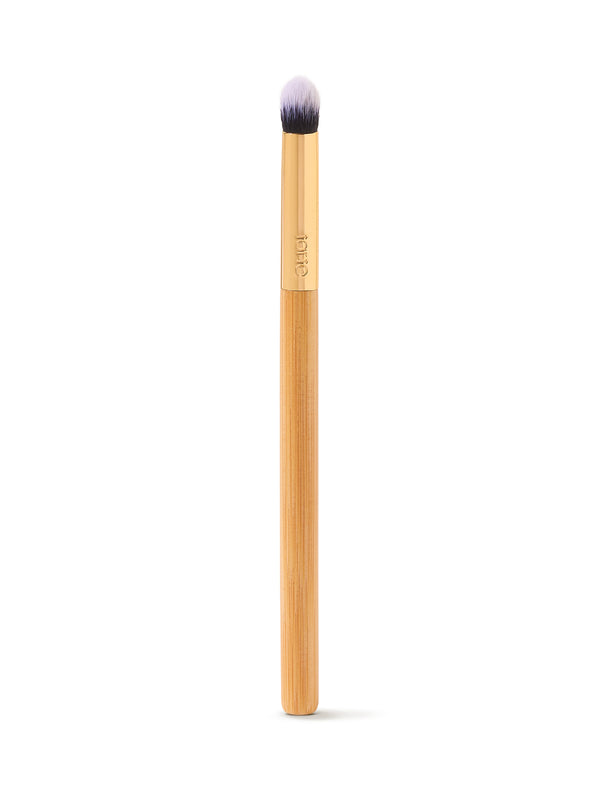 Makeup brush with a wooden handle on a white background