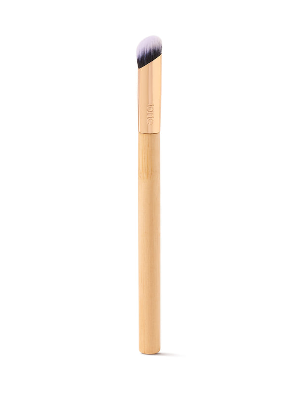 Makeup brush with wooden handle and black bristle head on a white background