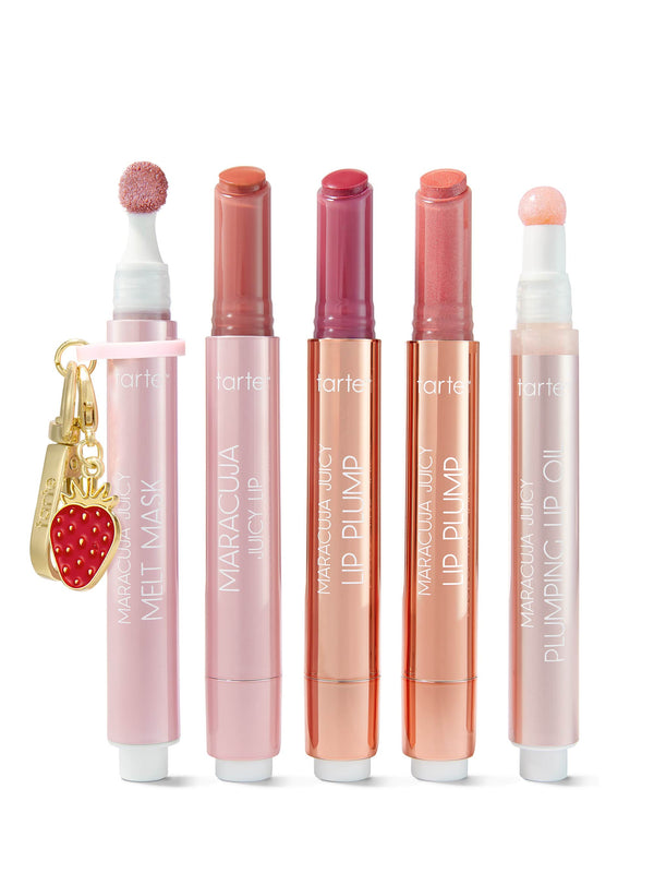 Tarte makeup set with lip products and a strawberry charm on a white background