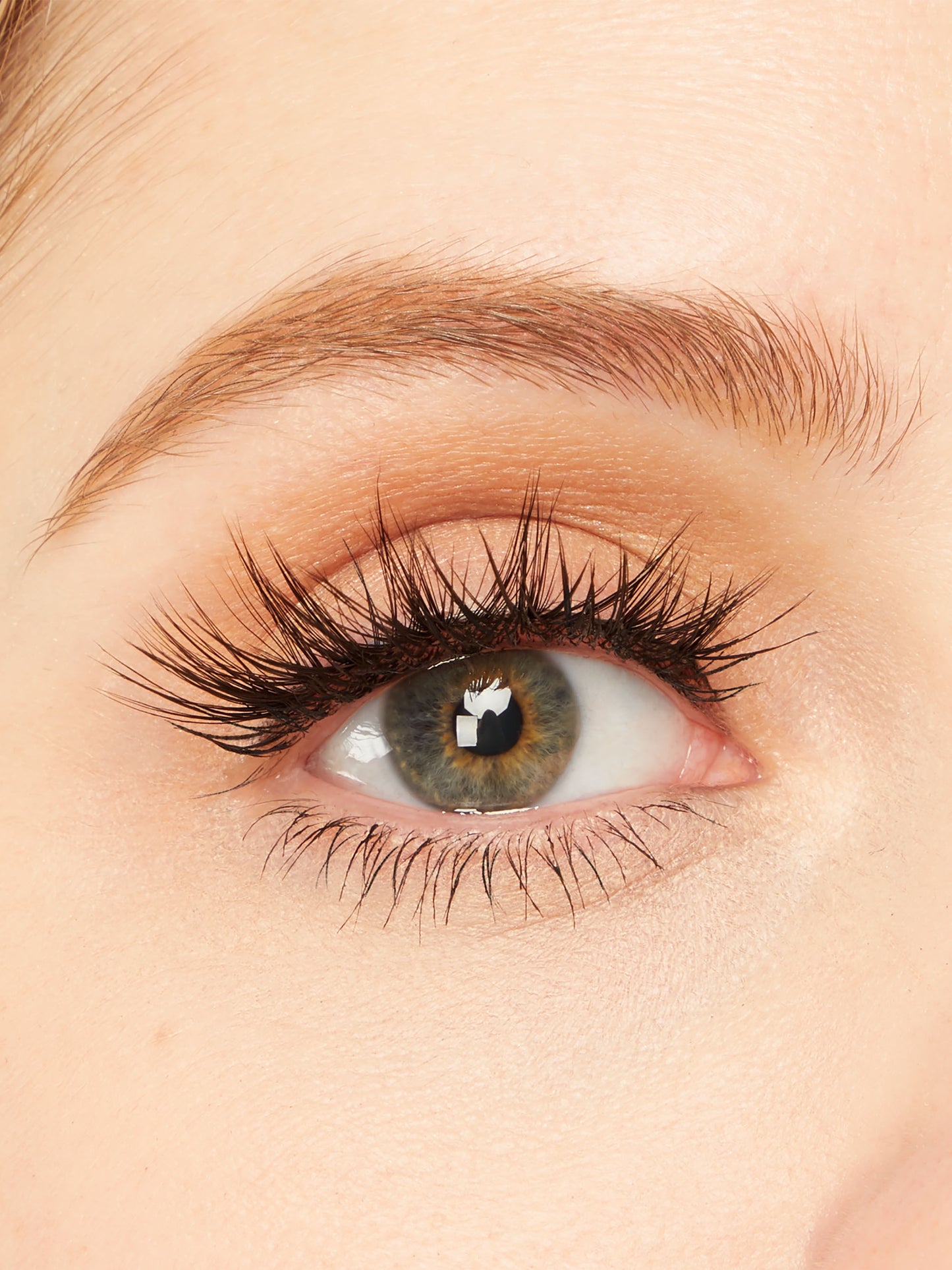 Close-up of a person's eye with detailed eyelashes and skin texture.