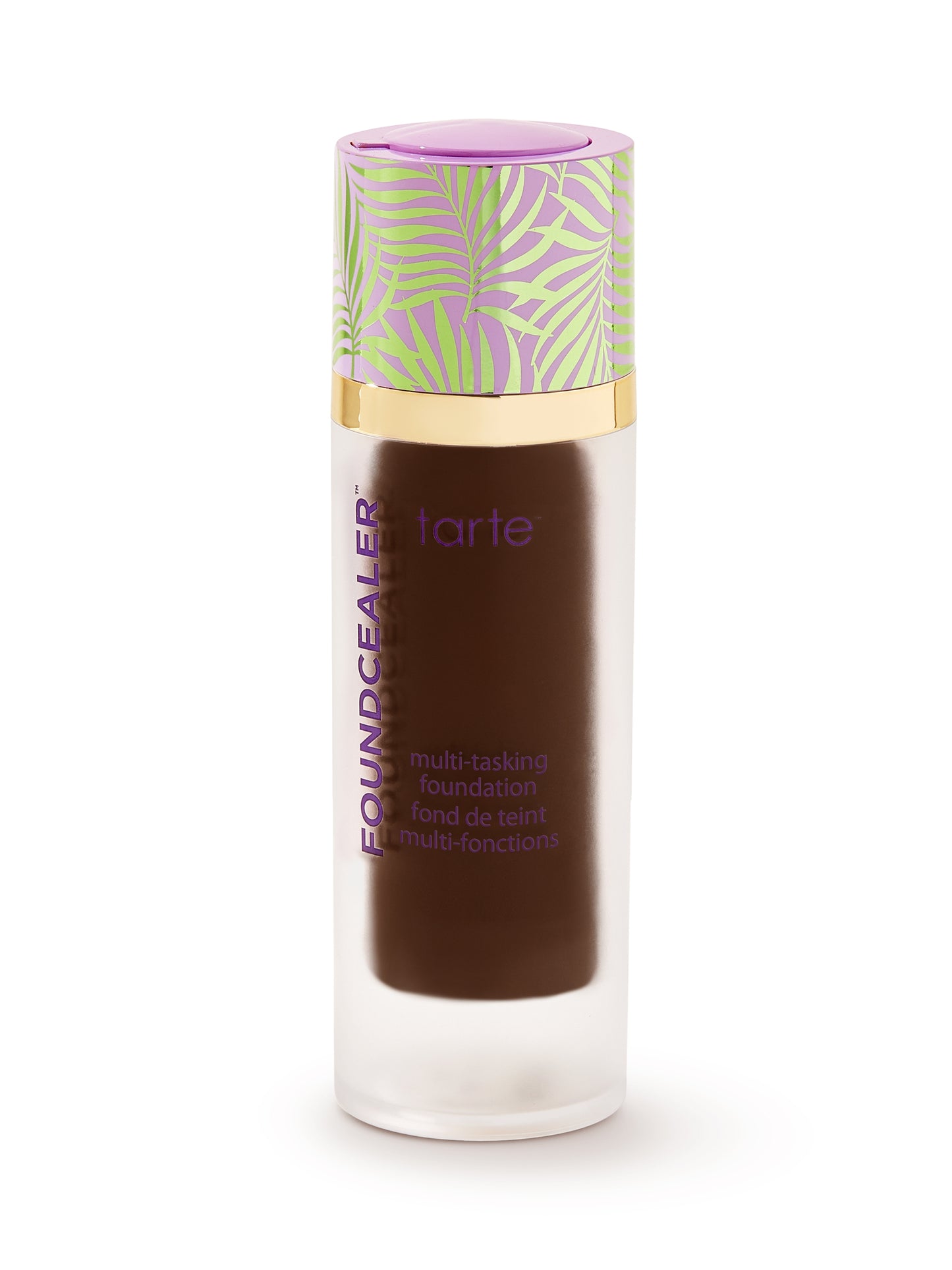 A cylindrical bottle features a purple and gold cap with leaf designs, containing dark liquid. Text reads: FOUNCEALER™ tarte multi-tasking foundation fond de teint multi-fonctions. It's isolated on a white background.