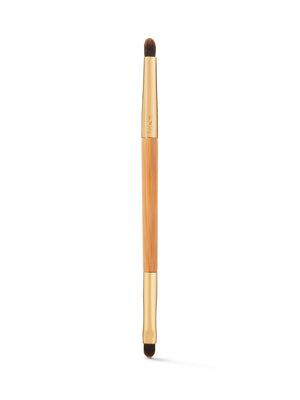 Makeup brush with wooden handle and black bristles on a white background
