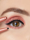 Close-up of a person applying makeup to their eye with a brush.