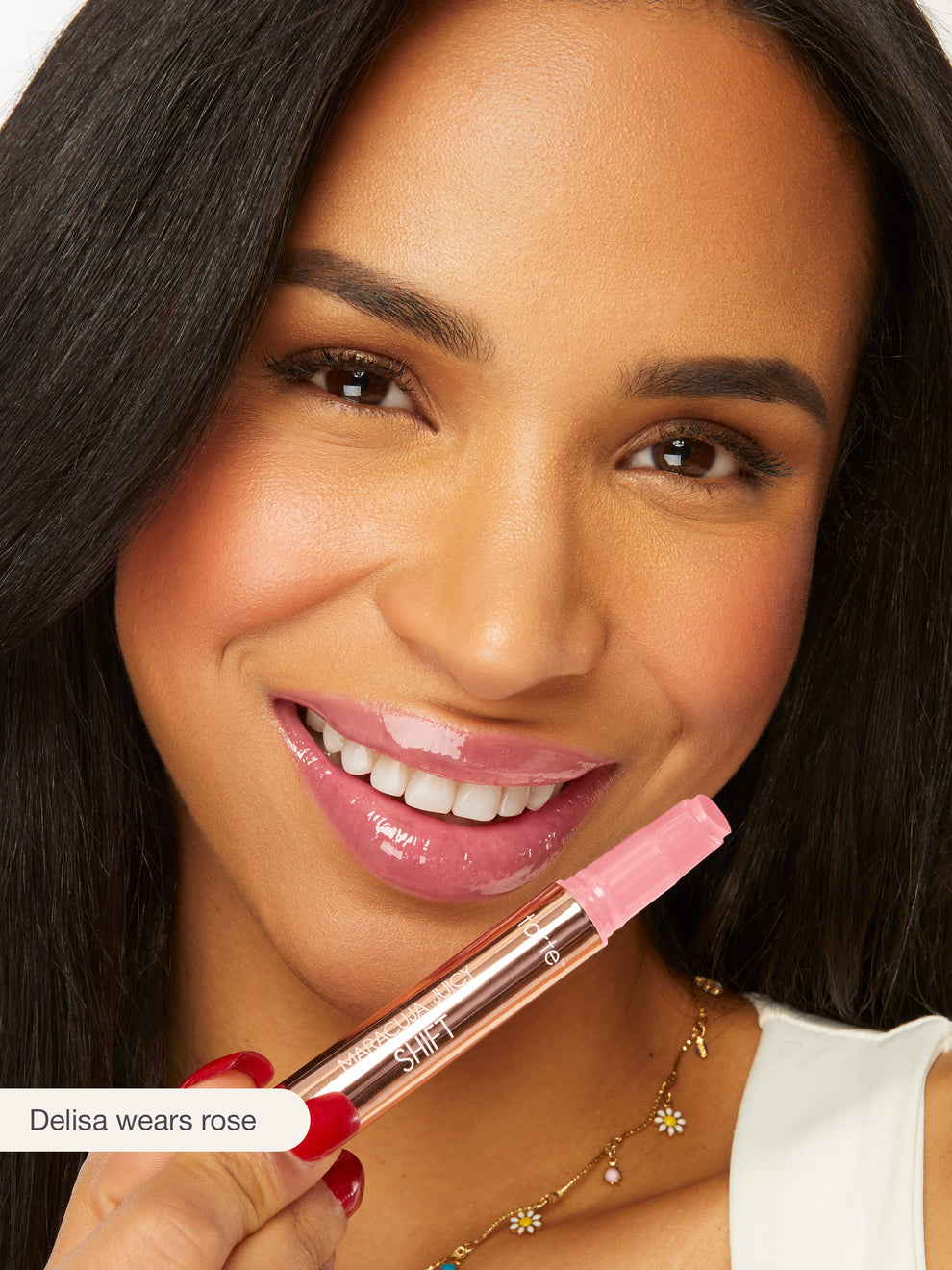 Woman holding a pink lipstick with a close-up of her face.